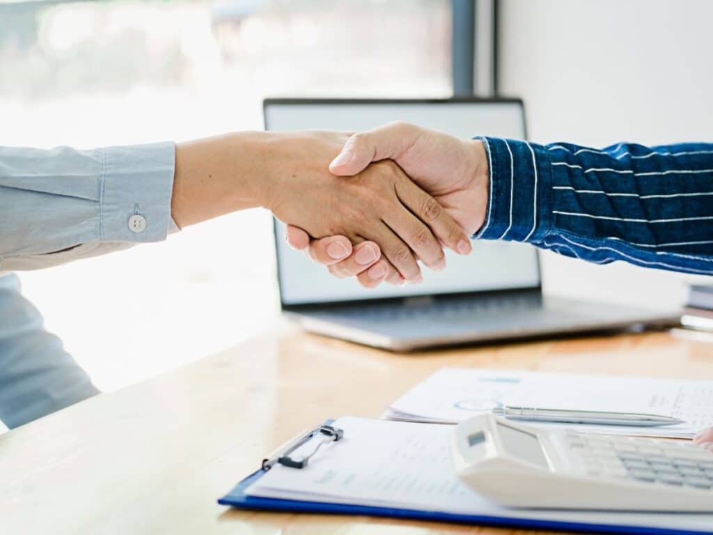 Financial planner shaking hands with a client