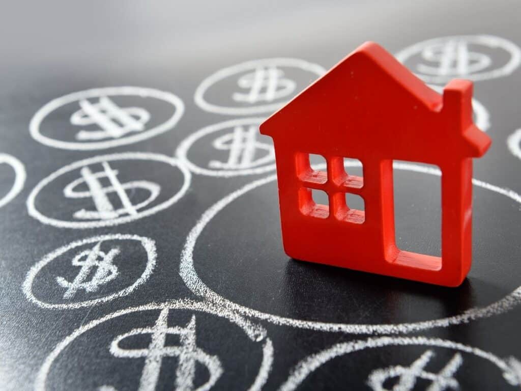 Model house with dollar signs around it, representing cost of living in Australia
